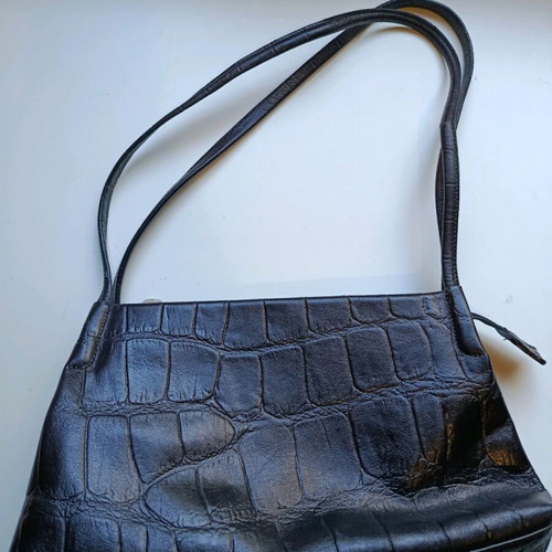 Black shoulder bag used with sturdy construction and multiple pockets