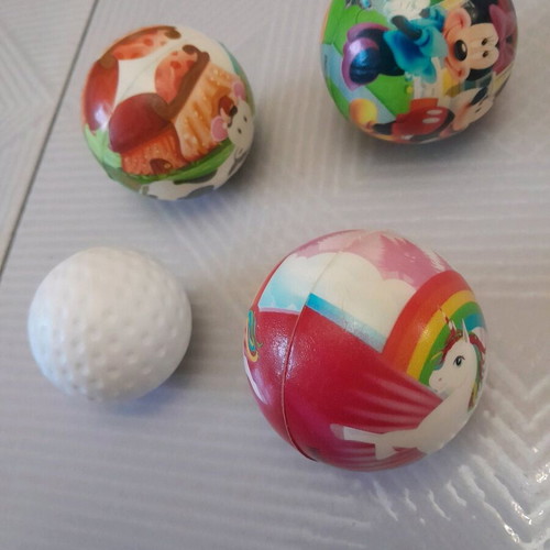 Balls set of 4, like new, 3 with drawings and 1 golf ball