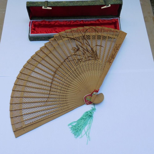 Traditional Chinese sandalwood fan with decorative tassel