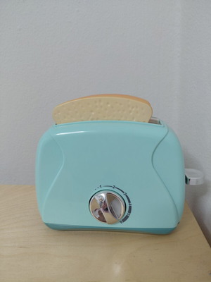 Toy Toaster like new with realistic functions and two fake bread slices
