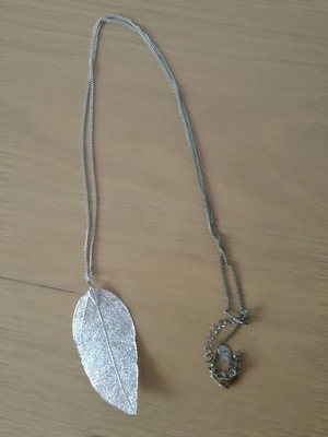 Long silver necklace with laser cut leaf