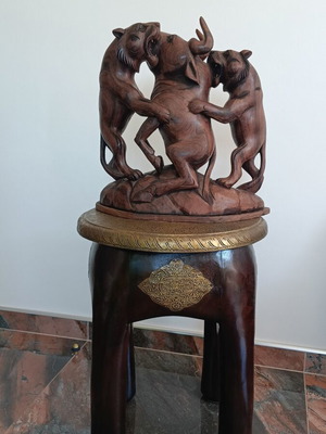 Hunting scene with buffalo and predators wood carving