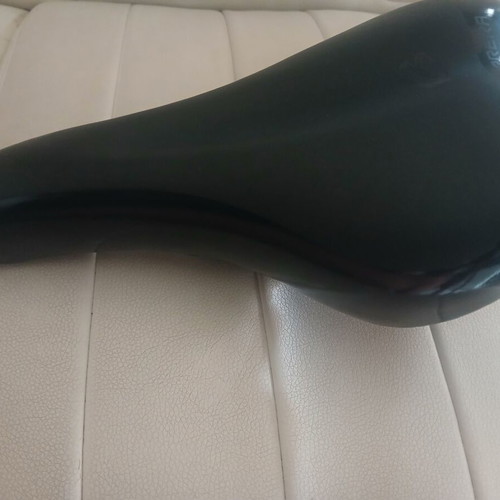 Carrera bicycle saddle like new with integrated rail clamp black