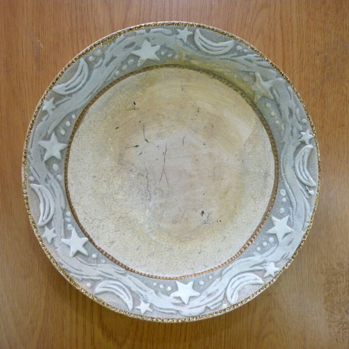 Decorative ceramic plate with embossed stars and moons like new