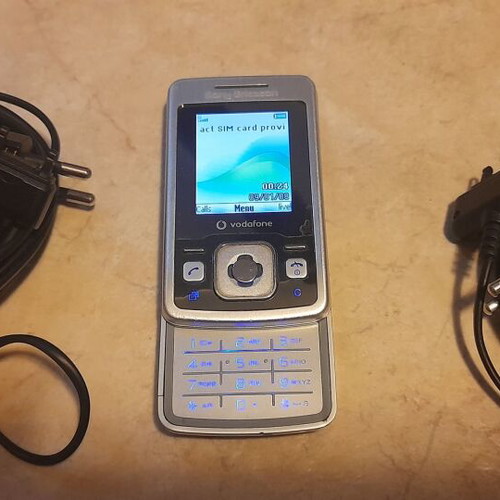 Sony Ericsson cell phone used with 2 chargers silver