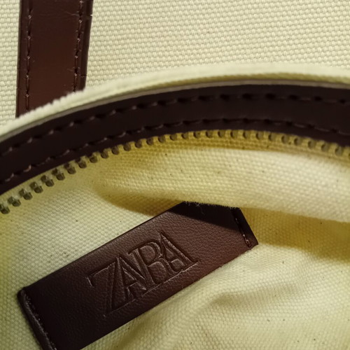 Large beige fabric shoulder bag with brown leather details