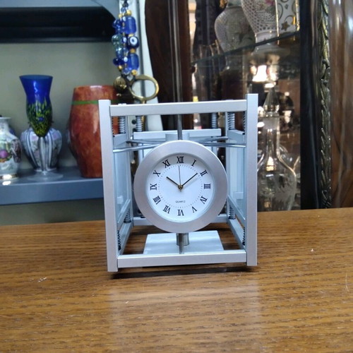 Quartz table clock silver color rotating, like new