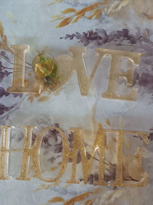 Decorations made of liquid glass with flowers and gold dust for home