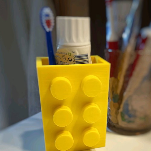 Plastic container in Lego brick shape for toothbrushes