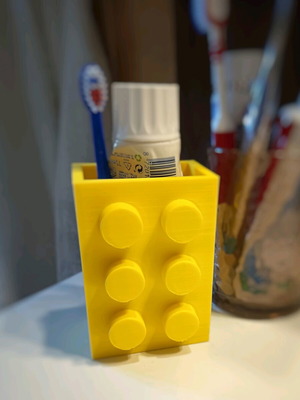 Plastic container in Lego brick shape for toothbrushes