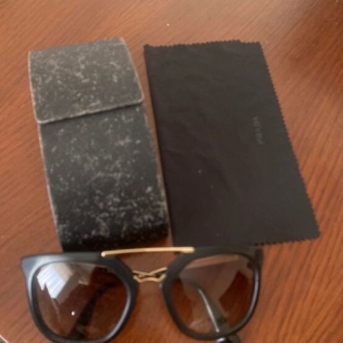 Prada sunglasses in black with gold details