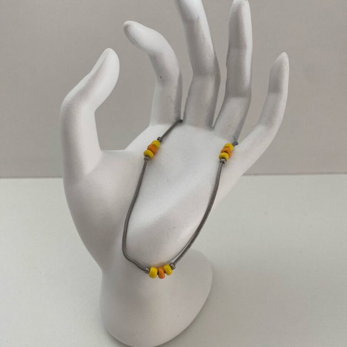 Silver bracelet used with orange and yellow beads