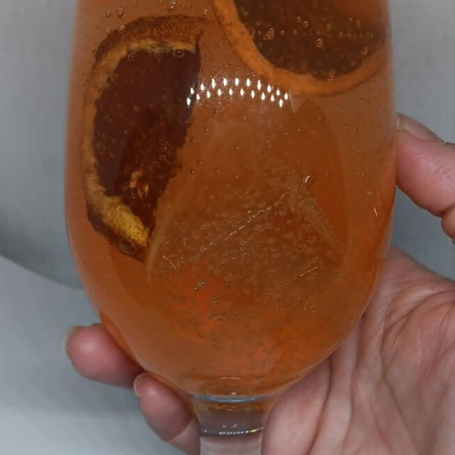 Handmade candle in Aperol Spritz glass with Aperol Spritz scent