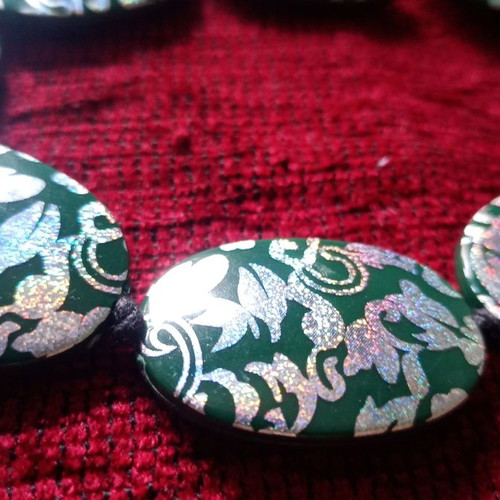 Acrylic green necklace used with holographic silver floral details