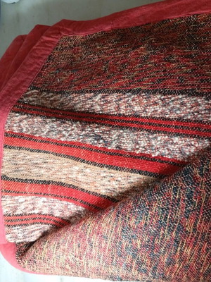 Woven throw used with traditional Greek weaving