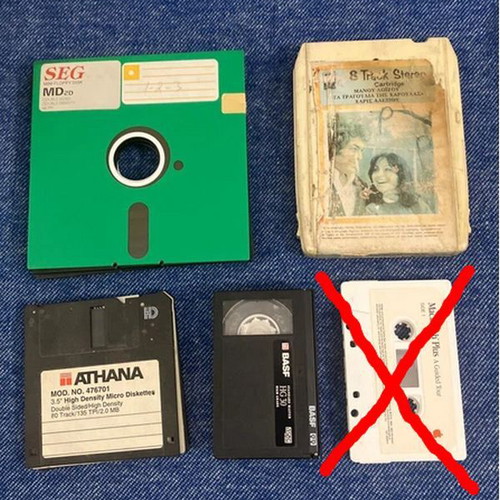 Vintage pack of used floppy disks and cassettes with 8-track and VHS