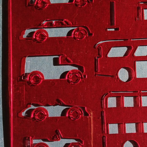 Red plastic stencil with vehicle designs