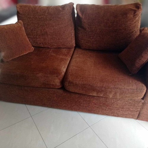 Two-seater sofa used, warm brown color, removable cushion covers