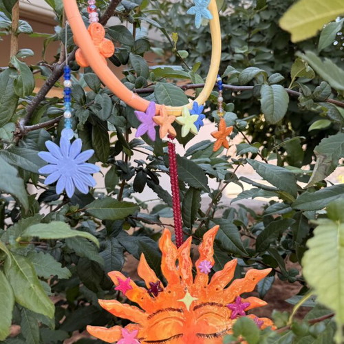 Handmade clay mobile with sun and flowers