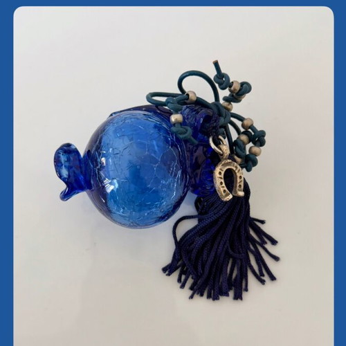Handmade glass lucky charm in blue shades with horseshoe and silk tassel