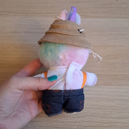 Labubu doll with pastel pink, purple, and blue clothes like new