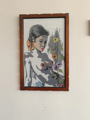 Handmade cross-stitch embroidery in wooden frame, used