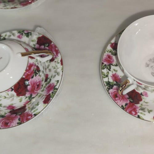 Vintage porcelain tea cups set with floral rose pattern and lithophany