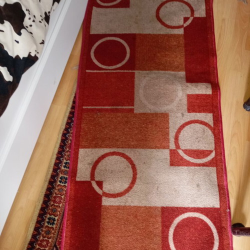 Vintage carpet runner used with geometric motifs in warm colors