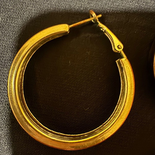 Thick silver hoop earrings used with some imperfections