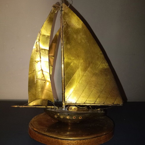 Vintage brass sailboat sculpture on wooden base, used
