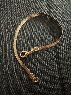 Gold plated bracelet snake chain herringbone style, worn with oxidation spots