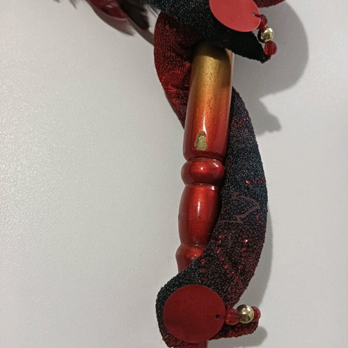 Mask with handle used, burgundy shades with minor wear