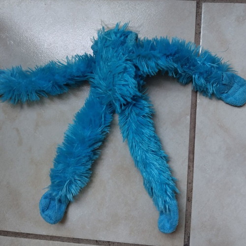 Stuffed chimpanzee hanging like new