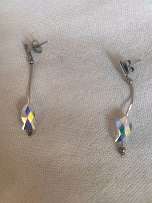 Silver dangling earrings used with design and stone