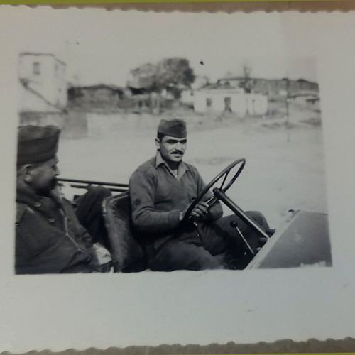 Vintage black and white photo of Greek soldiers in military jeep like new