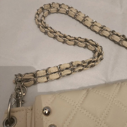 Women's shoulder bag like new, milky color with silver details
