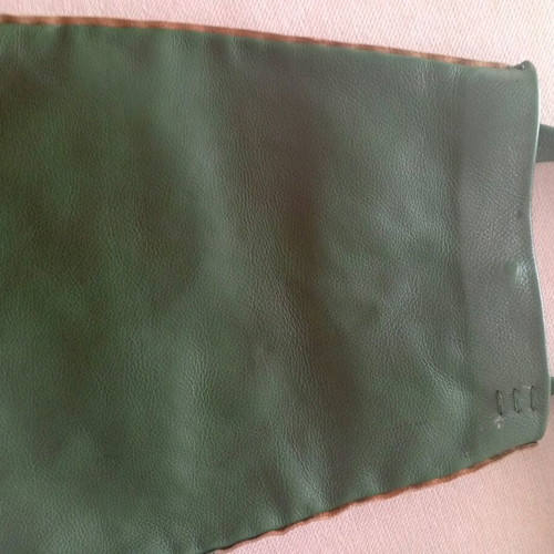 Handmade leather shoulder bag used in deep green boho style