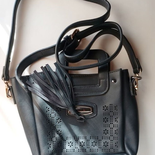 Black Women's Shoulder Bag like new with laser-cut patterns and tassels