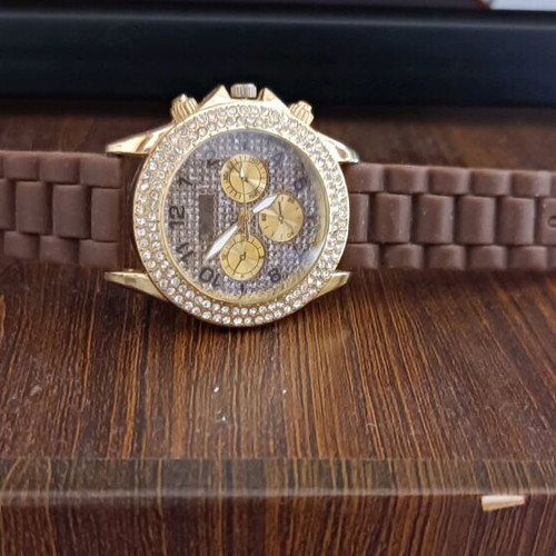 Watch with brown rubber strap and stones on dial like new