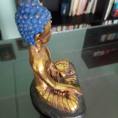 Golden ceramic Buddha statue sitting meditation decoration