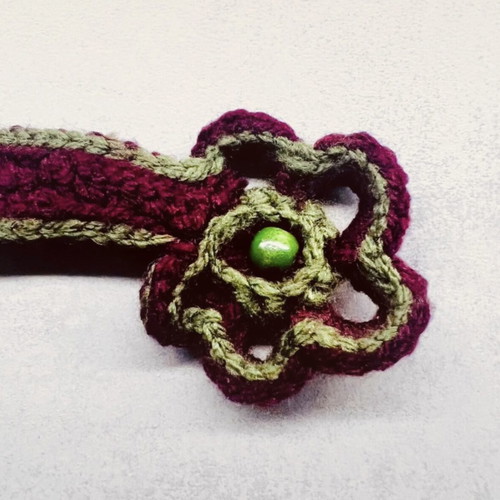 Handmade knitted bracelet with flower