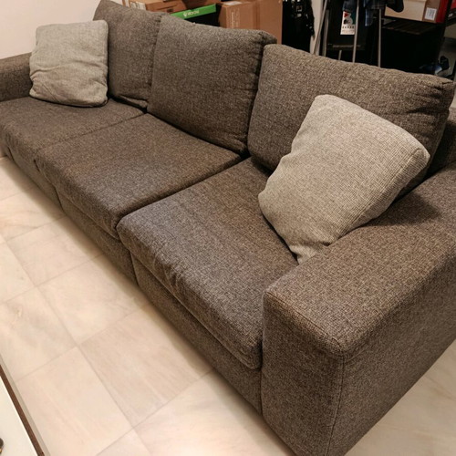 Three-seater sofa used in gray color with two cushions