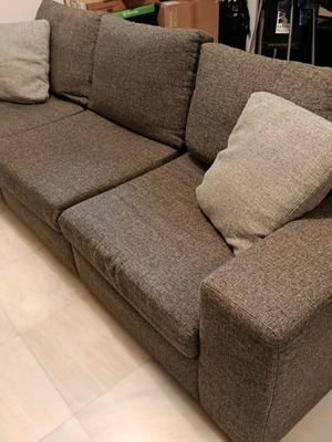 Three-seater sofa used in gray color with two cushions