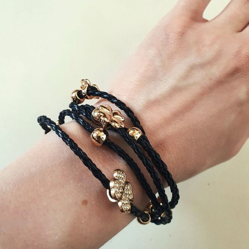 Black braided bracelet with gold beads and crystal clover like new