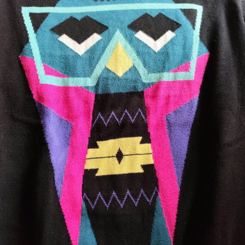Black sweater used, medium size with loose fit and small hole