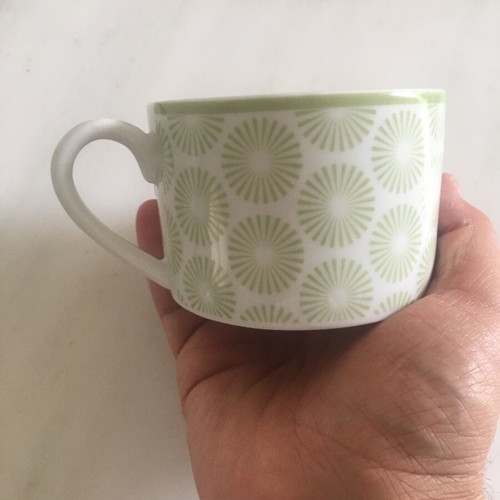 Vintage porcelain cup with light green daisy decorations like new