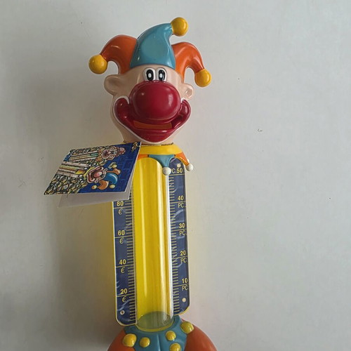 Vintage clown coin bank with yellow coin tube