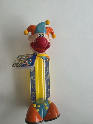 Vintage clown coin bank with yellow coin tube