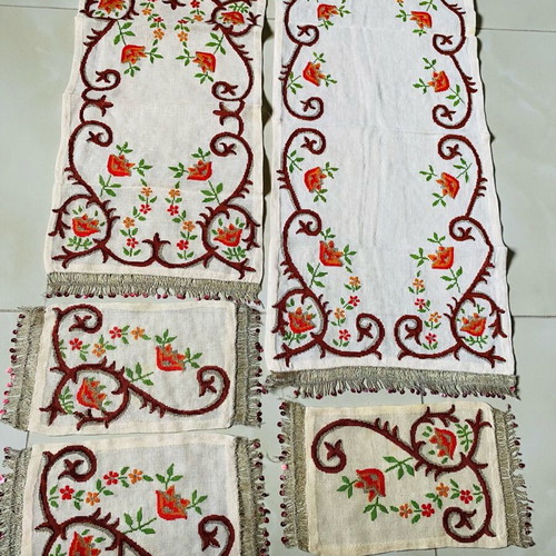 Set of embroidered handmade table linens used