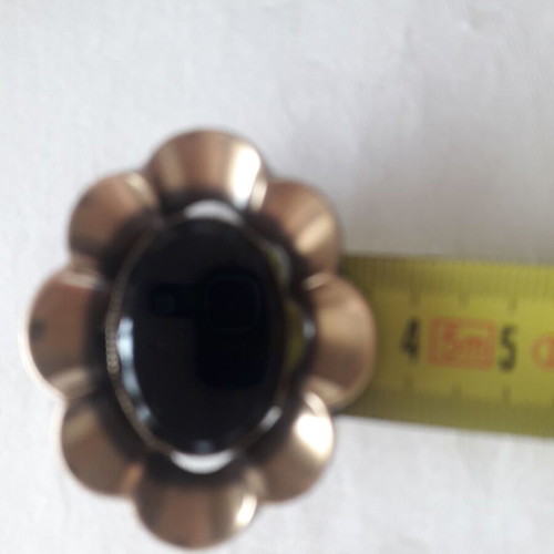 Tie pin like new with oval black stone and gold-colored design